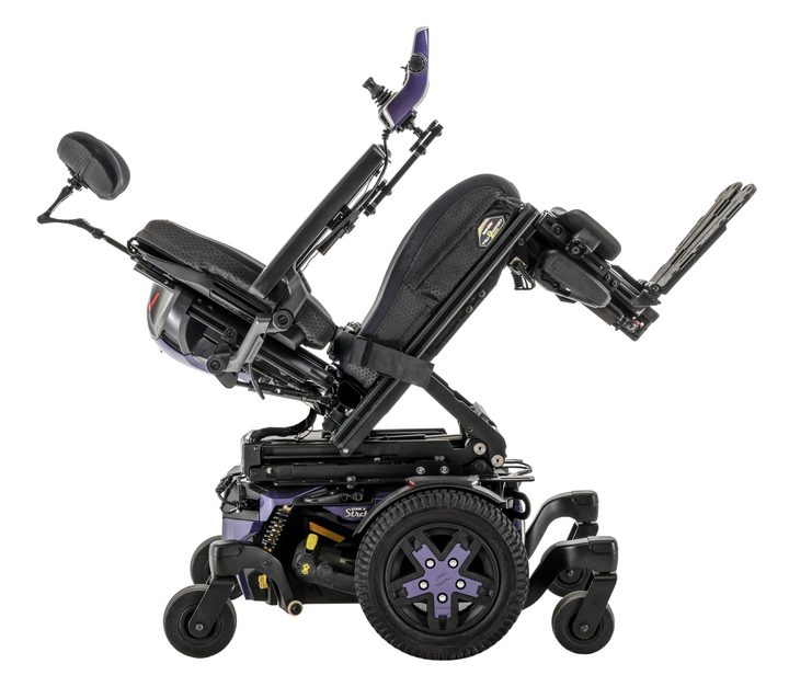 A complex-rehab power chair with its seat tilted back, showing the tilt-in-space range.