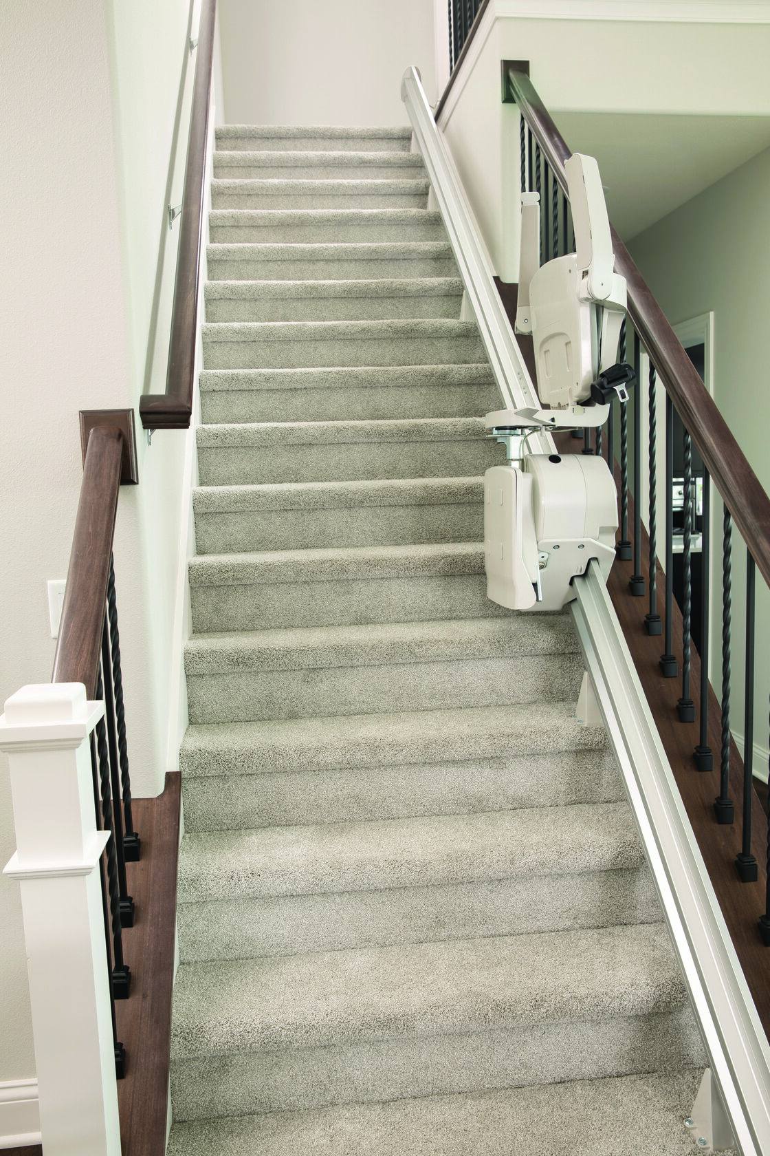 A stairlift rail fitted to a straight indoor staircase.