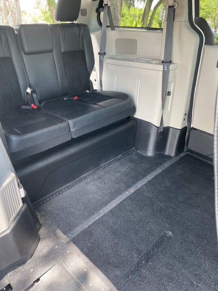 Inside the van: the second-row bench and the lowered floor beside it, with the ramp track running to the door.